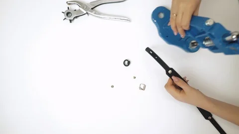 Process of working with a leather product. Use of a press machine for rivets Stock Footage 105094246
