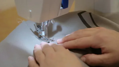 The process of working as a seamstress on a sewing machine Stock Footage 150313000