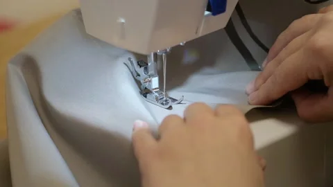 The process of working as a seamstress on a sewing machine Stock Footage 150313014