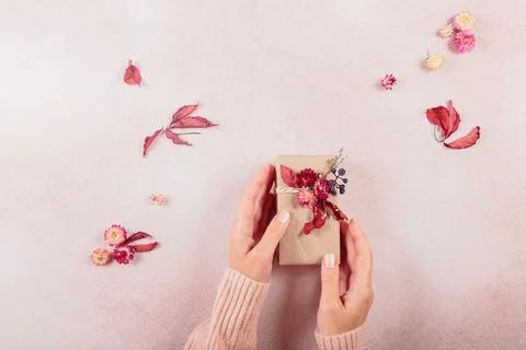 Process of wrapping and decorating presents with dried flowers Stock Photos
