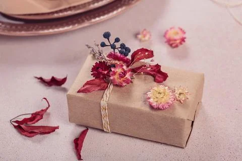 Process of wrapping and decorating presents with dried flowers Stock Photos