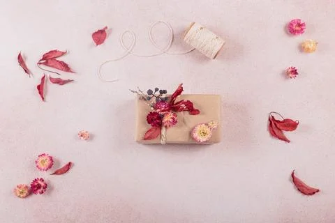 Process of wrapping and decorating presents with dried flowers Stock Photos