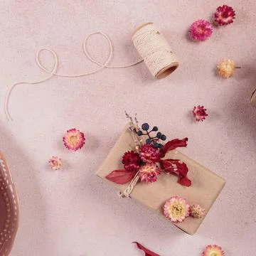 Process of wrapping and decorating presents with dried flowers Stock Photos