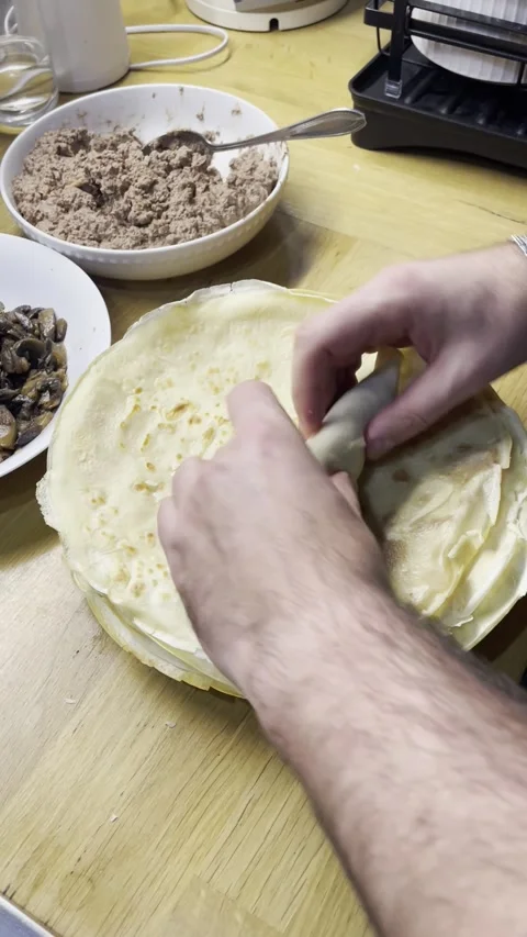 The process of wrapping pancakes with filling Video stock 329423040