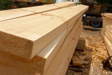 Processed boards at a sawmill. Smooth, turned, polished boards at a wood proc Stock Photos