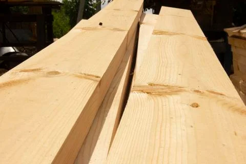 Processed boards at a sawmill. Smooth, turned, polished boards at a wood proc Stock Photos
