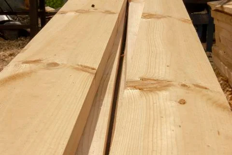 Processed boards at a sawmill. Smooth, turned, polished boards at a wood proc Stock Photos