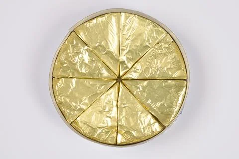 Processed Cheese Triangles in Golden Foil Stock Photos