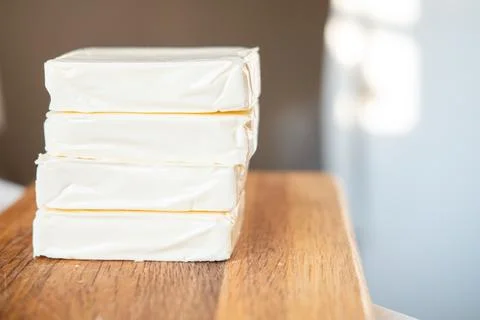 Processed cheese, without packaging on a wooden background Stock Photos