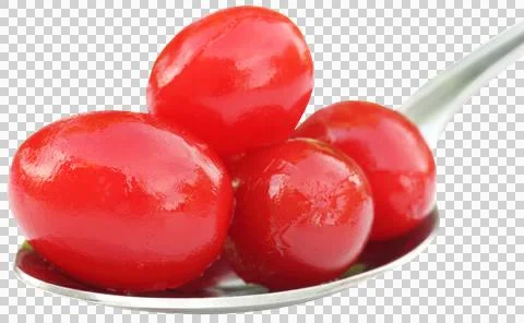 Processed cherry on a silver spoon Stock Photos