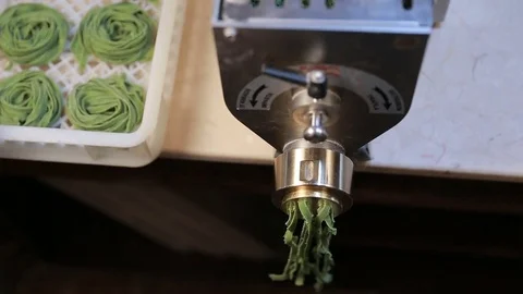 Processed green spaghetti pasta on machine tray at kitchen Stock Footage 72755418