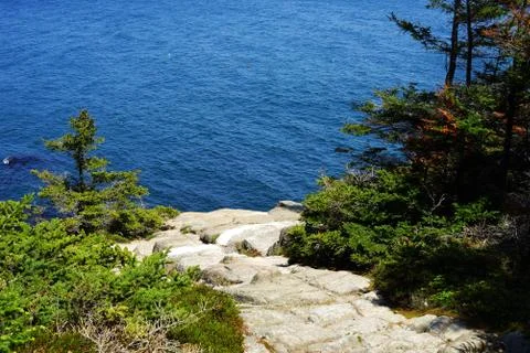 Processed by: Helicon Filter; A stony trail to the blue water among green con Stock Photos