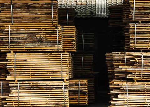 Processed lumber packed and stacked Stock Photos