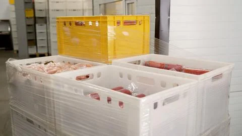 Processed meat products packed in plastic crates Stock Photos