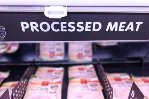Processed Meat signage at the meat section of supermarket with defocused back Stock Photos