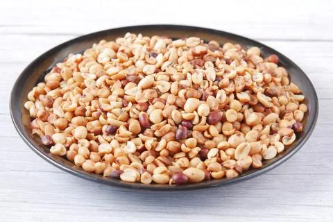 Processed pea nuts in a bowl on table top down . Stock Photos