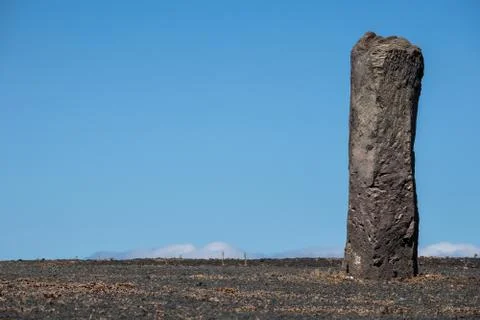 Processed stone column against the blue sky Stock Photos