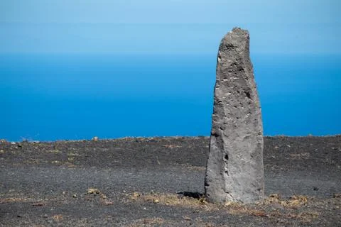 Processed stone column against the blue sky Stock Photos