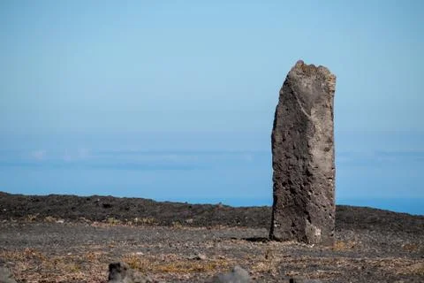 Processed stone column against the blue sky Stock Photos