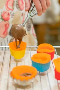Processes of preparation of chocolate muffins close-up on the table. Woman Co Stock Photos