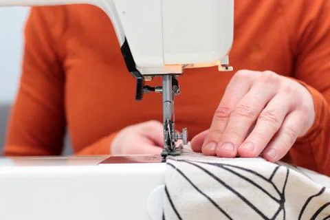 Processes of sewing flax on the sewing machine sew women's hands sewing machi Stock Photos