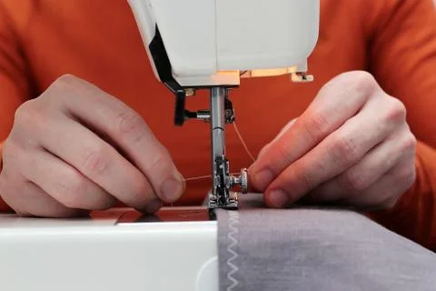 Processes of sewing flax on the sewing machine sew women's hands sewing machi Stock Photos