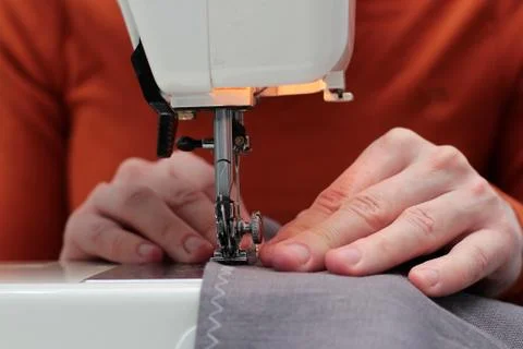 Processes of sewing flax on the sewing machine sew women's hands sewing machi Stock Photos