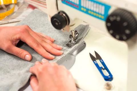 Processes of sewing on the sewing machine sew women's hands sewing machine Stock Photos