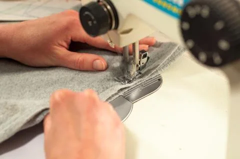 Processes of sewing on the sewing machine sew women's hands sewing machine Stock Photos