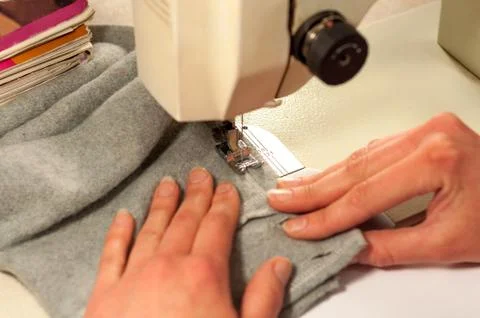 Processes of sewing on the sewing machine sew women's hands sewing machine Stock Photos