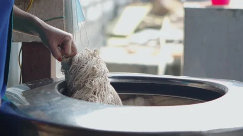 Processing Colored Yarn, Soaking, Drying and Dying Stock Footage 127990196