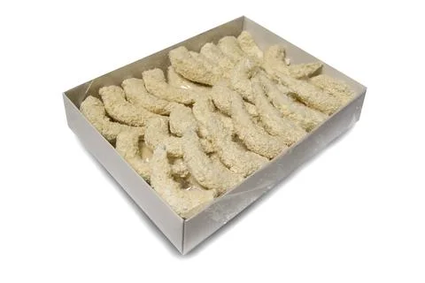 Processing of crispy breaded shrimps in a standard factory box isolated Stock Photos
