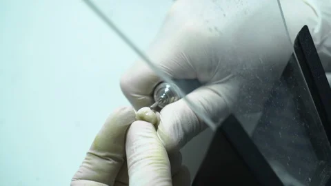 Processing of dental crowns with a drill machine. laboratory. close-up Stock Footage 117572484