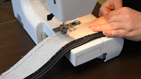 Processing details of clothes on a sewing machine close up Stock Footage 133179936