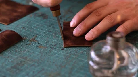 Processing the edges of leather workpieces with crimping tool. Stock Footage 150477600
