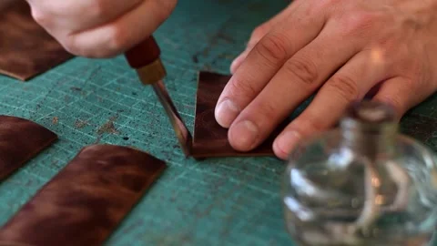Processing the edges of leather workpieces with crimping tool. Stock Footage 150477763