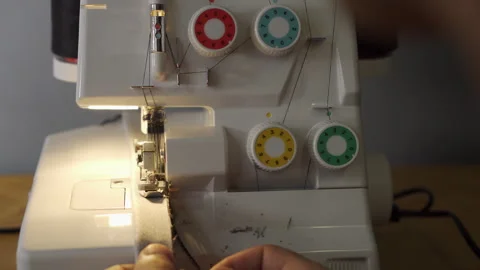 Processing a fabric part on an overlock. Close-up Stock Footage 282200833