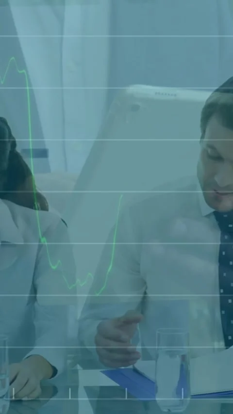 Processing financial data, business professionals working at table with Stock Footage 319822694
