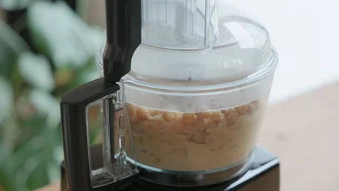 Processing Fresh Ingredients to Create a Healthy Chickpea Puree or Hummus Stock Footage 326642566