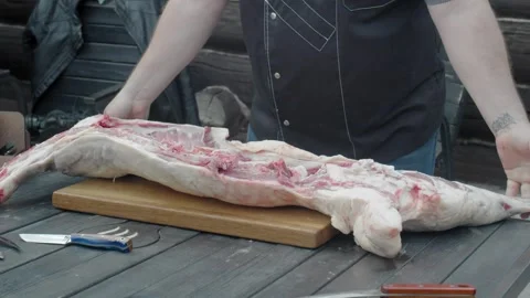 Processing of fresh young lamb carcass on summer sunny day Stock Footage 247761544