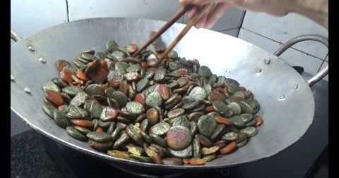 Processing gac seeds into herbal medicine Stock Footage 312855438