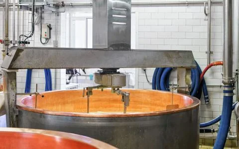 Processing of Gruyere de Comte Cheese at dairy in France Stock Photos