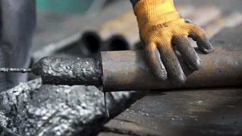 Processing the inside of the pipe with graphite grease Stock Footage 176849457