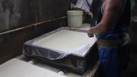 Processing of making tofu. an Indonesian man makes tofu the traditional way. Stock Footage 211917857