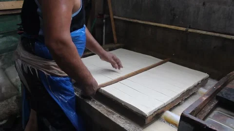 Processing of making tofu. an Indonesian man makes tofu the traditional way. Stock Footage 214231692