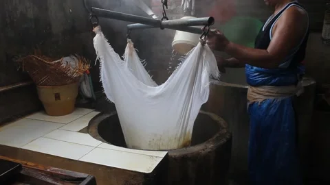 Processing of making tofu. an Indonesian man makes tofu the traditional way. Stock Footage 214231867