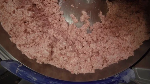 Processing of meat in the food industry on a cutter Stock Footage 99552558
