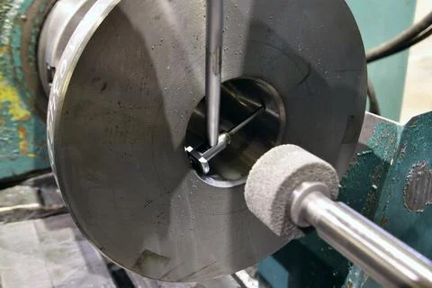 Processing of metal by grinding on a flat grinding machine Stock Photos