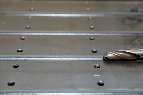 Processing of metal products and drilling holes in metal pillars. Metalworking Stock Photos