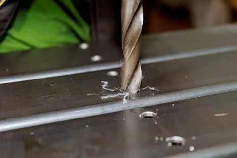 Processing of metal products and drilling holes in metal pillars. Metalworking Stock Photos